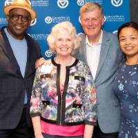 tom and marcia pose with a couple at the photo station